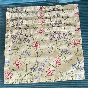 Four Crate & Barrel light yellow colorfully embroidered placemats